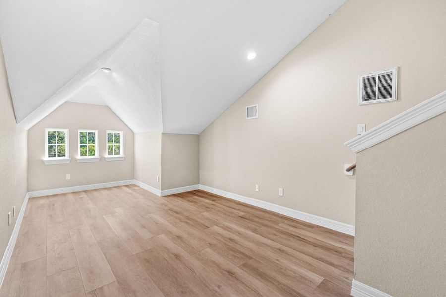 Another versatile upstairs space perfect for a home gym, study, or secondary living area.