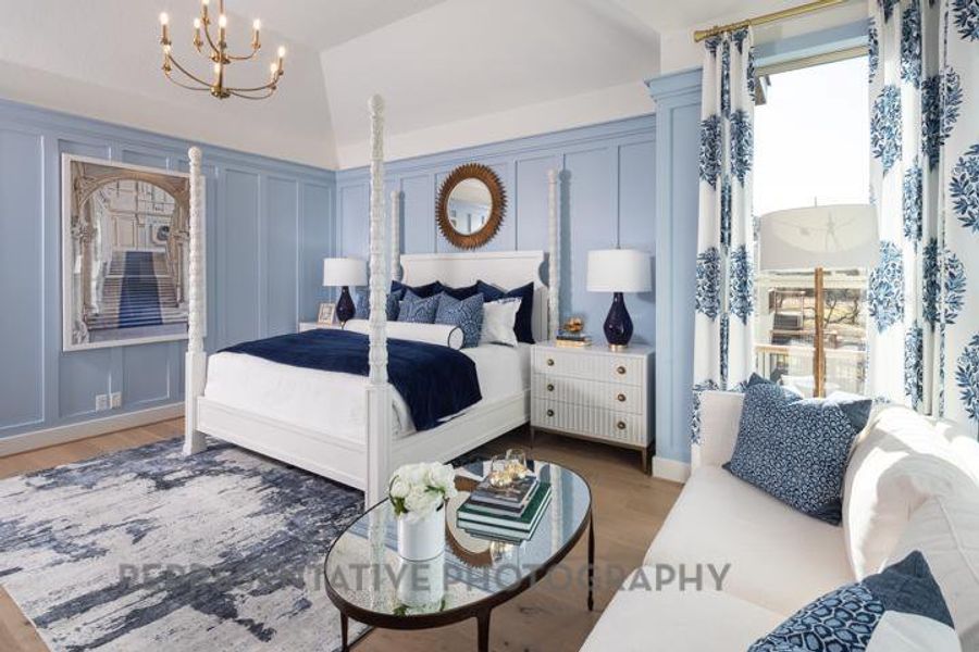 Bedroom with a chandelier, wood finished floors, a decorative wall, and multiple windows Bedroom with a chandelier, wood finished floors, a decorative wall, and multiple windows