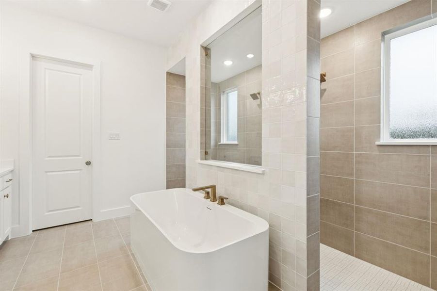 You'll enjoy an owner's bath that features a double walk through shower and free standing tub when you call this over the top home your own! You'll enjoy an owner's bath that features a double walk through shower and free standing tub when you call this over the top home your own!