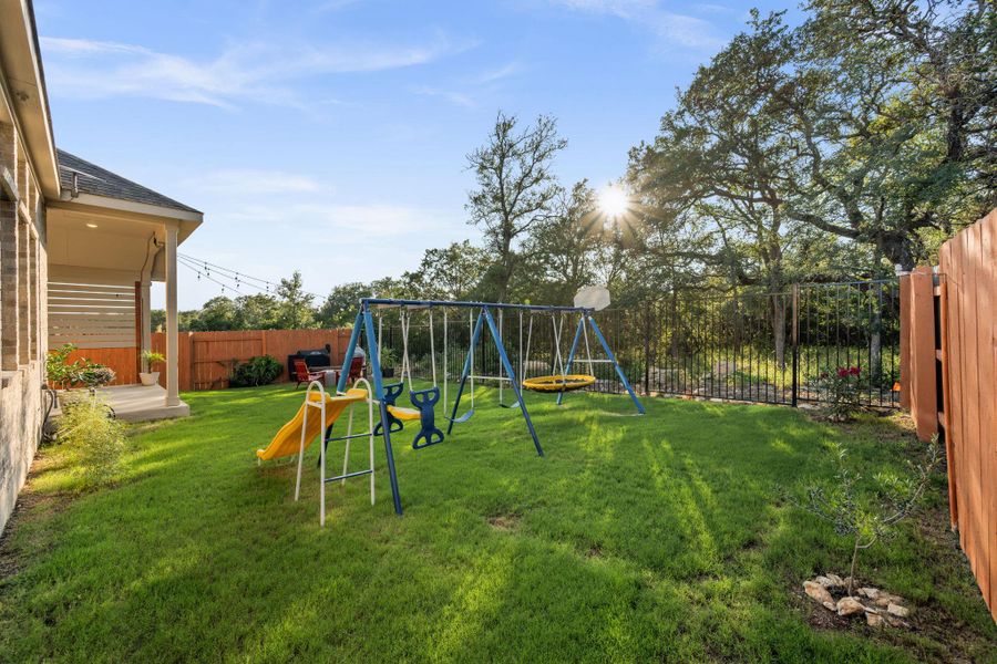 A well-maintained lawn offers ample space for recreation, complemented by a covered patio ideal for outdoor relaxation. A well-maintained lawn offers ample space for recreation, complemented by a covered patio ideal for outdoor relaxation.