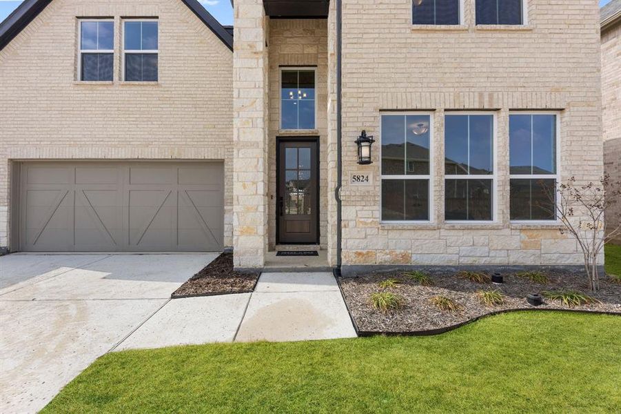 With a beautiful combination of light colored brick and stone, you will love welcoming friends and family into your new home!