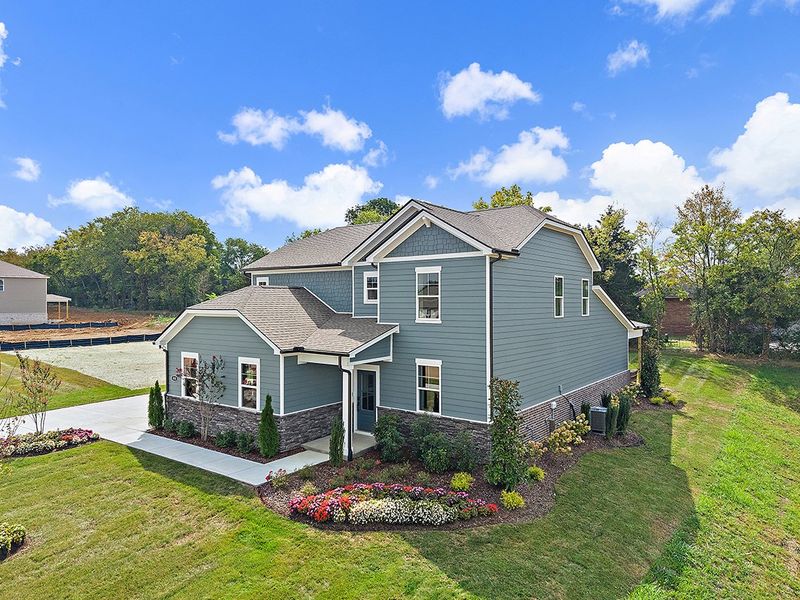 A house with a garden in the front. A house with a garden in the front.