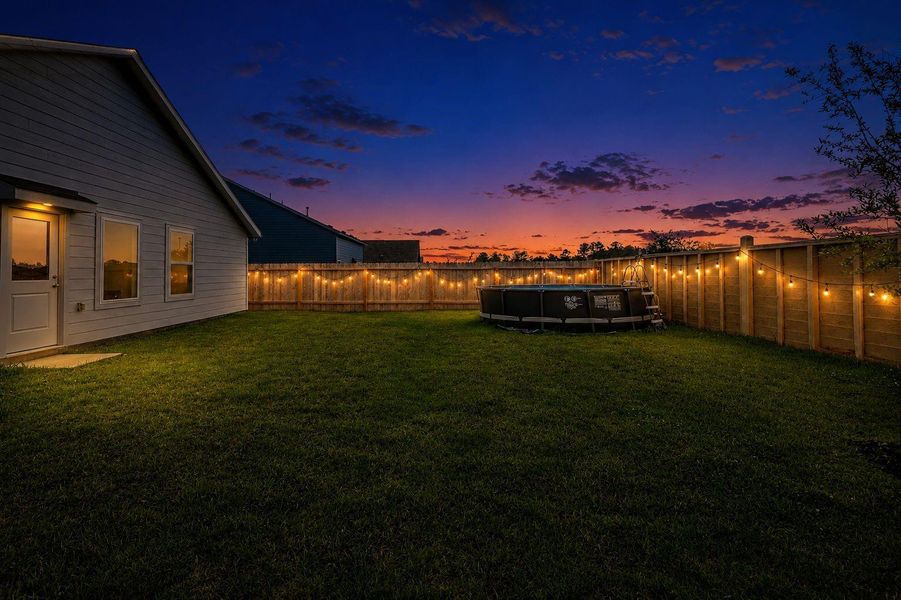Relaxing twilight view of the large backyard. Relaxing twilight view of the large backyard.