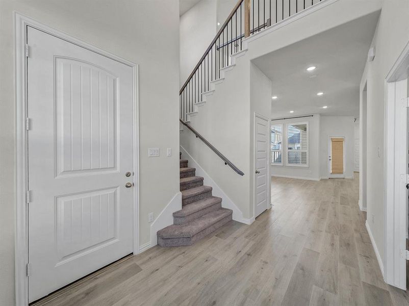 Foyer entrance with light wood-type flooring