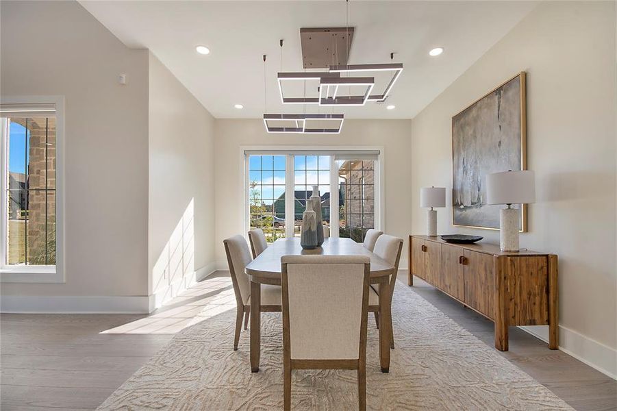 Dining room with light wood finished floors and recessed lighting Dining room with light wood finished floors and recessed lighting