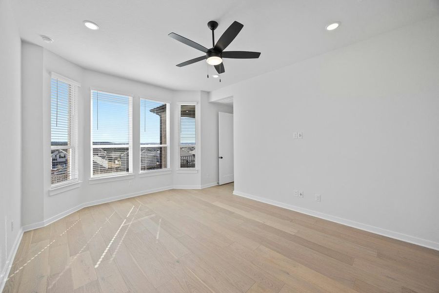 Empty room with light wood-style floors, recessed lighting, and a ceiling fan Empty room with light wood-style floors, recessed lighting, and a ceiling fan