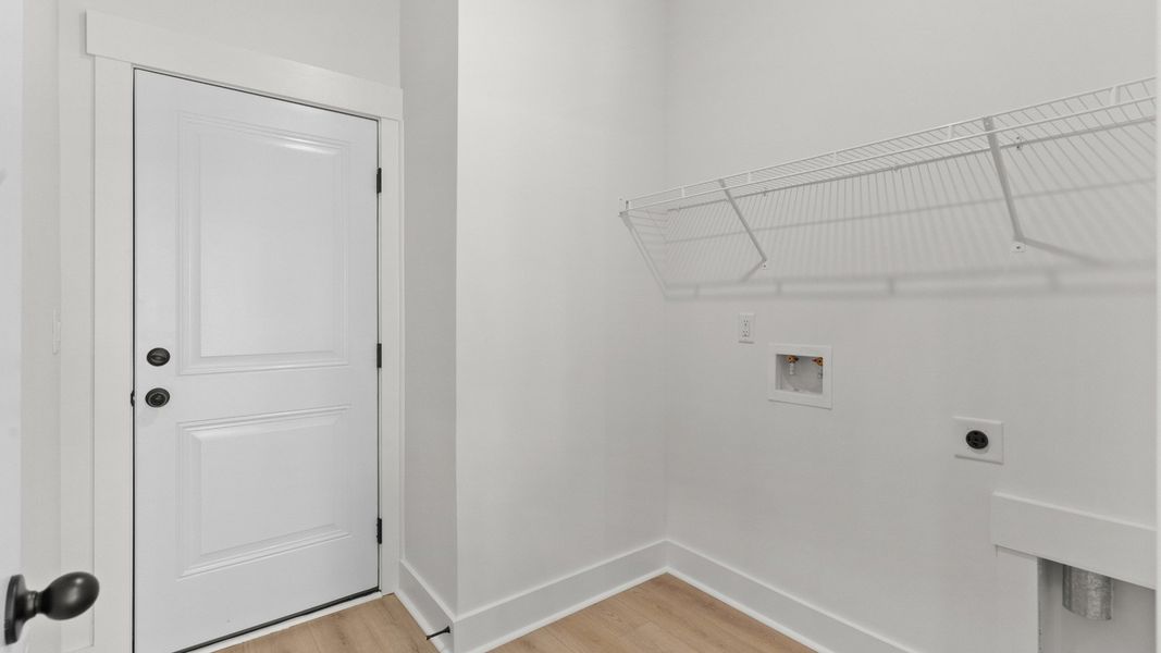A bright laundry room with storage keeps daily tasks simple.