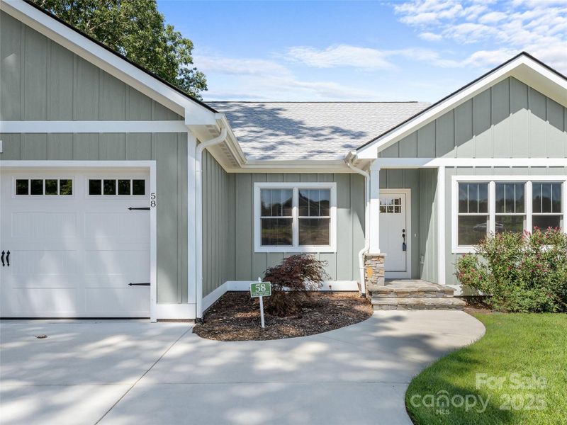 Front exterior of a new home in , Hendersonville, NC, highlighting curb appeal (Image 25).