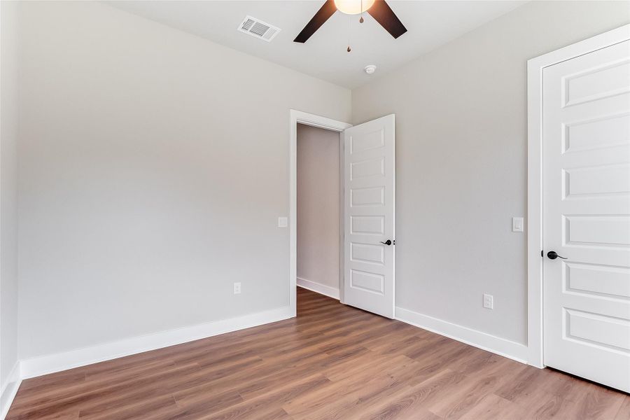 Unfurnished bedroom featuring light wood finished floors and a ceiling fan