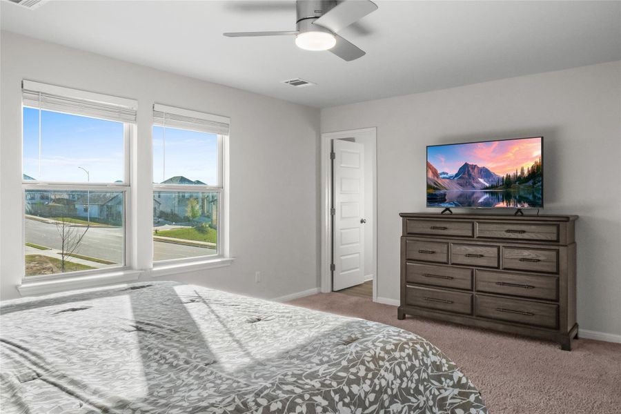 Bedroom featuring light colored carpet and ceiling fan