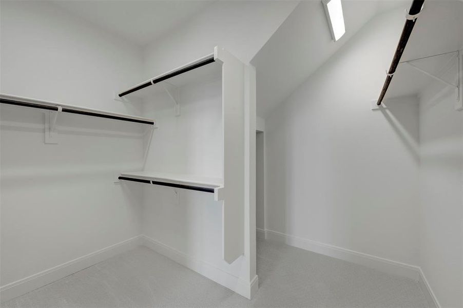 Walk in closet with light colored carpet Walk in closet with light colored carpet