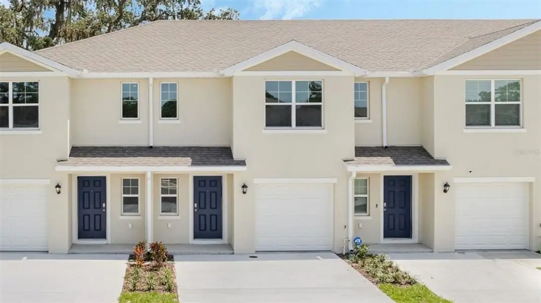 Front exterior of a new home in Sandalwood, New Smyrna Beach, FL, highlighting curb appeal (Image 1). Front exterior of a new home in Sandalwood, New Smyrna Beach, FL, highlighting curb appeal (Image 1).