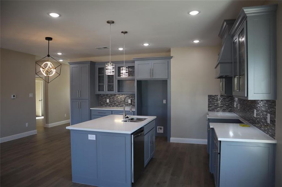 Kitchen with marble countertops and decorative light fixtures