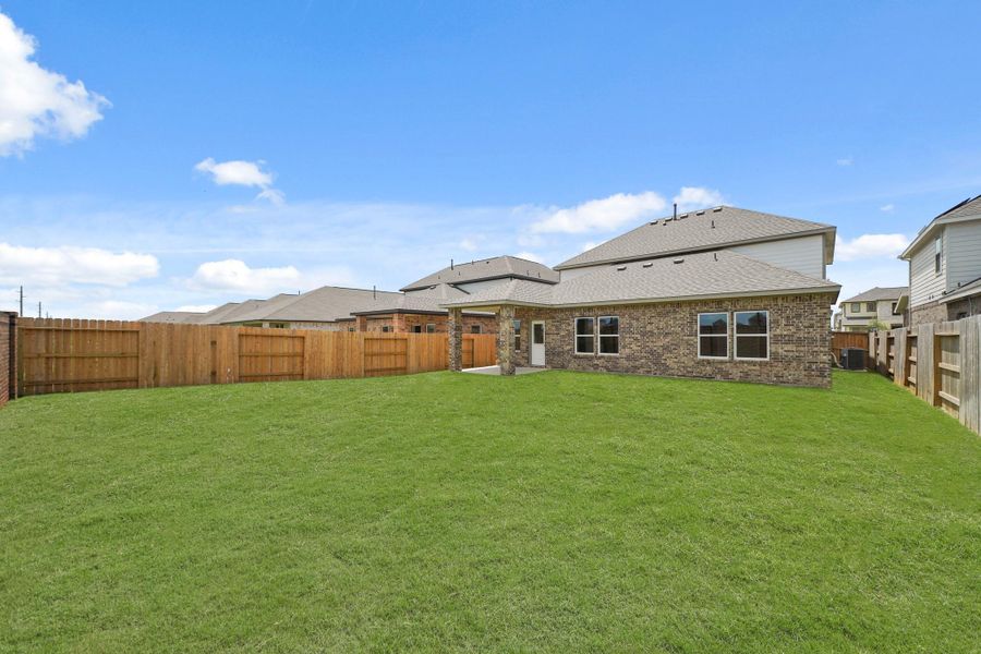 Front exterior of a new home in Sunterra, Katy, TX, highlighting curb appeal (Image 14).
