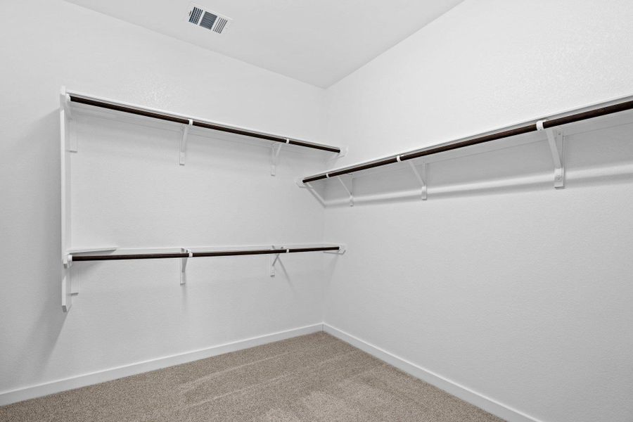 Walk-in closet in Primary Bedroom Walk-in closet in Primary Bedroom
