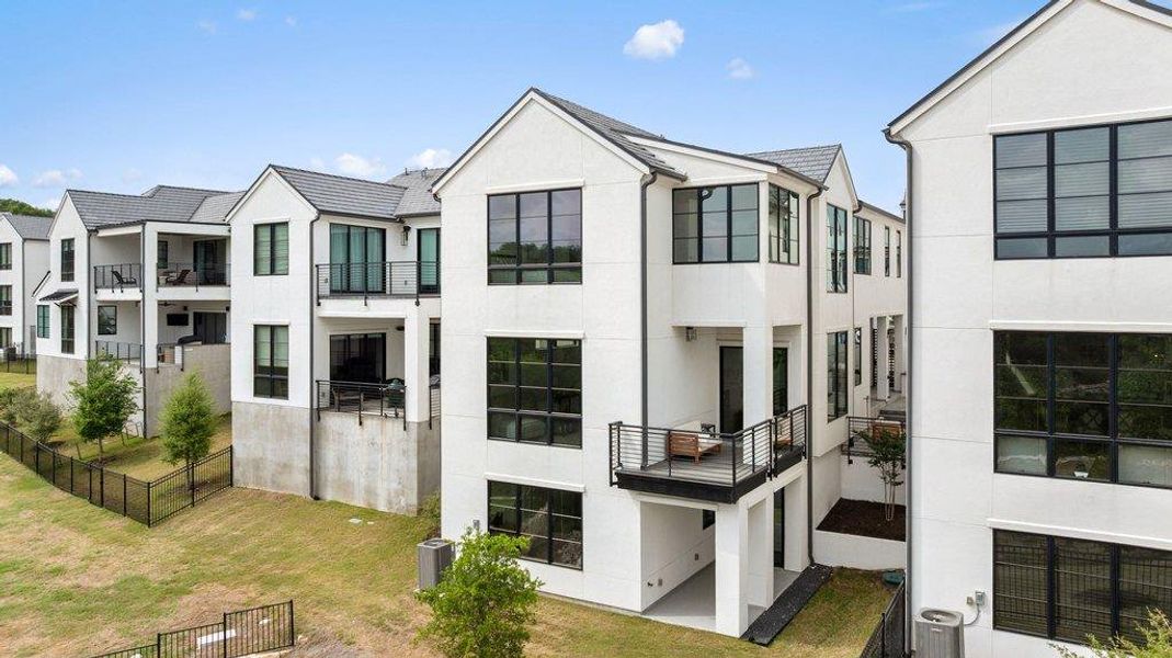 Modern white stucco exterior with prominent gables and dark-framed windows