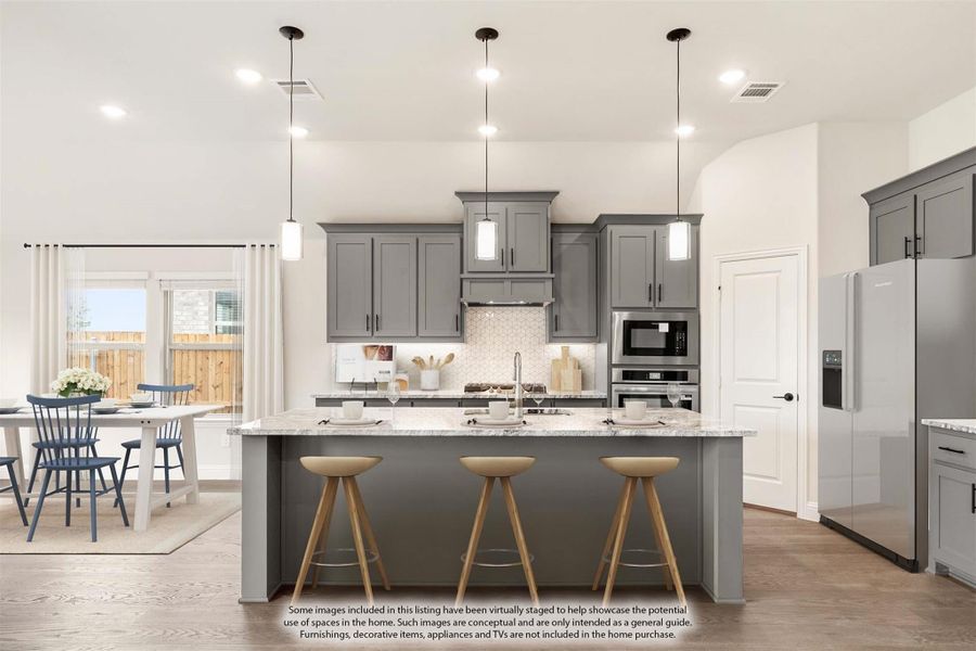 Kitchen with gray cabinets, granite island with three bar stools, stainless steel appliances, and pendant lights Kitchen with gray cabinets, granite island with three bar stools, stainless steel appliances, and pendant lights