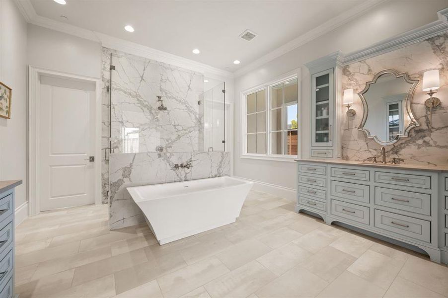 Full bathroom featuring vanity, a freestanding tub, a marble finish shower, recessed lighting, and crown molding Full bathroom featuring vanity, a freestanding tub, a marble finish shower, recessed lighting, and crown molding