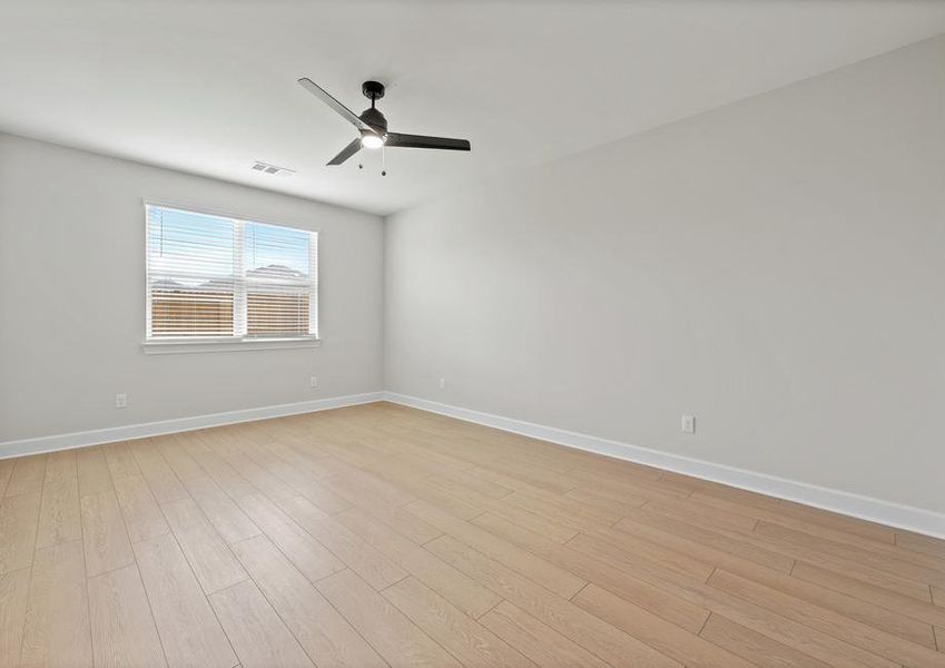 The master bedroom is large and has a window that lets in wonderful natural light.