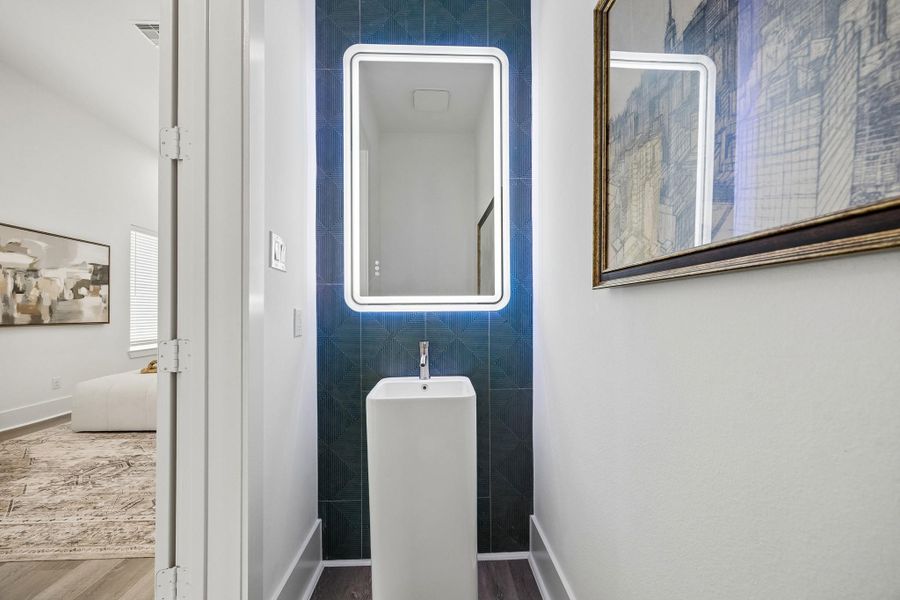 This powder room with its beautiful tile accent wall is tucked away near the second floor living area. This powder room with its beautiful tile accent wall is tucked away near the second floor living area.