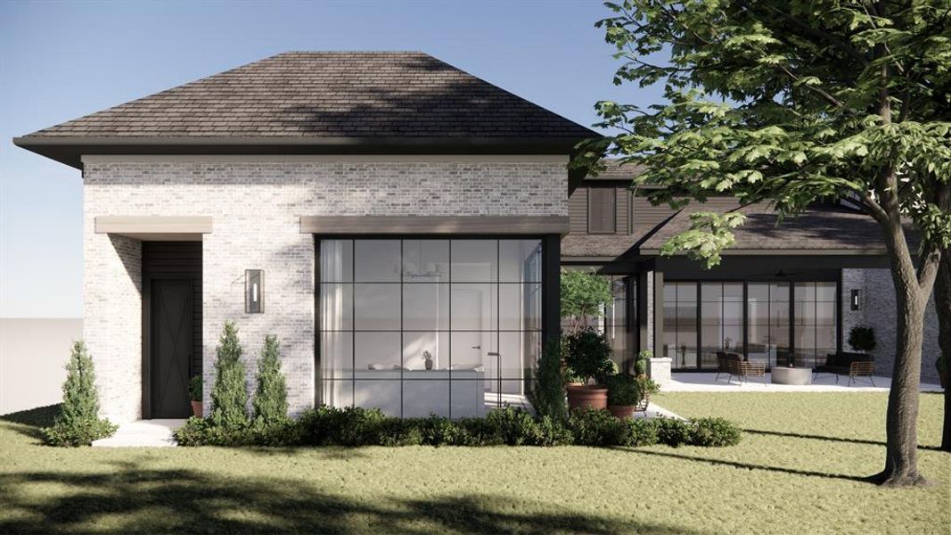 Rear view of property featuring brick siding, a patio, and a yard