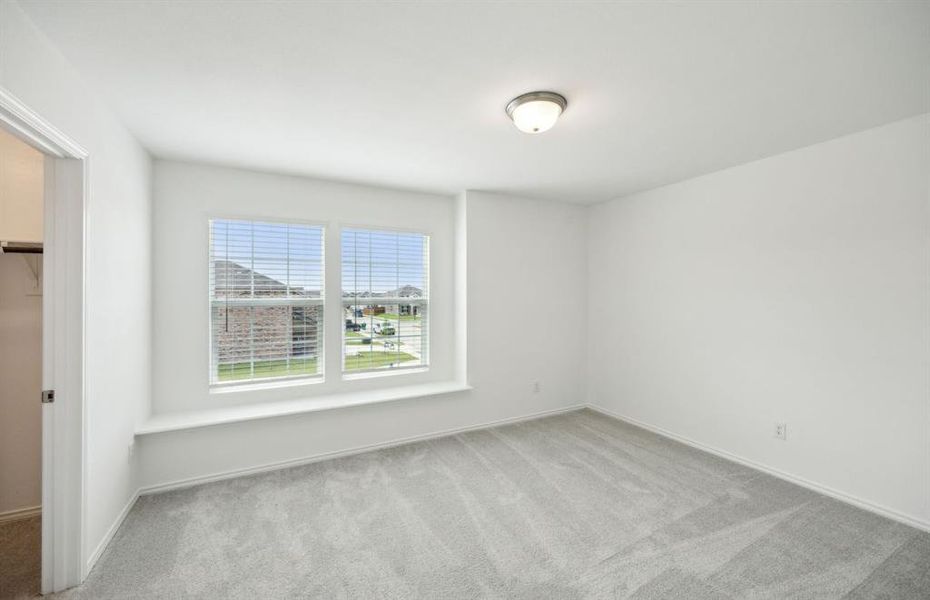 secondary bedroom with large window *real home pictured