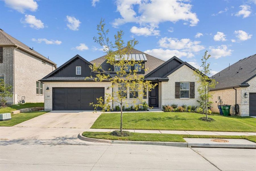 Front exterior of a new home in Monterra, Fate, TX, highlighting curb appeal (Image 2). Front exterior of a new home in Monterra, Fate, TX, highlighting curb appeal (Image 2).