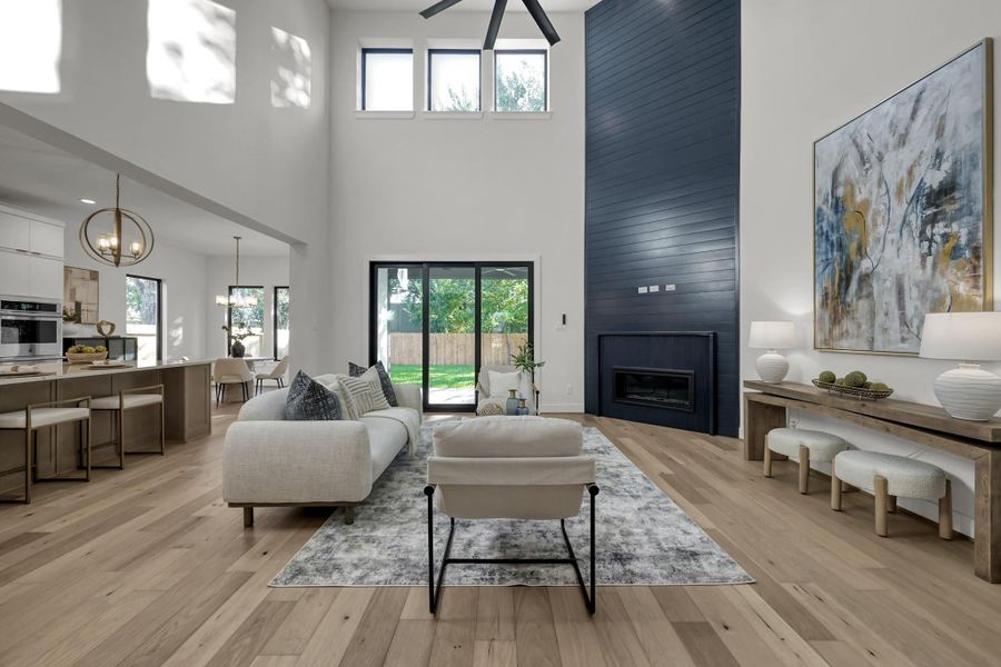 Open living area with soaring ceilings and floor-to-ceiling fireplace. Open living area with soaring ceilings and floor-to-ceiling fireplace.