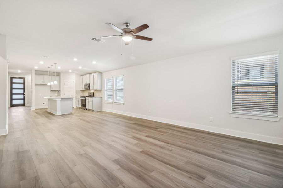 Living room and dining room in the Hughes floorplan at a Meritage Homes community.