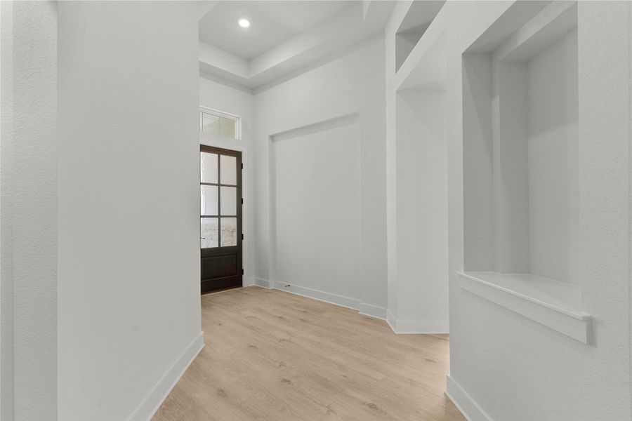 Hall featuring wood finished floors and recessed lighting Hall featuring wood finished floors and recessed lighting
