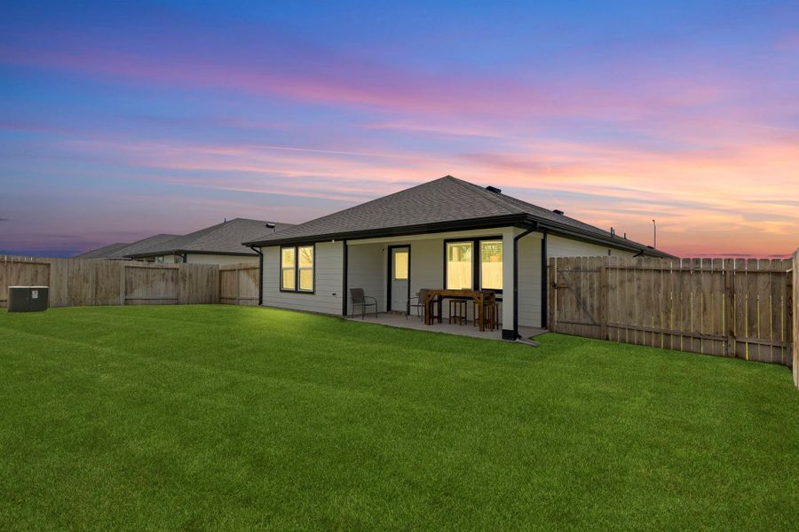 Gorgeous twilight look at the spacious backyard and extended covered patio, perfect for evening gatherings, outdoor dining, or simply relaxing under the Texas sky. Gorgeous twilight look at the spacious backyard and extended covered patio, perfect for evening gatherings, outdoor dining, or simply relaxing under the Texas sky.