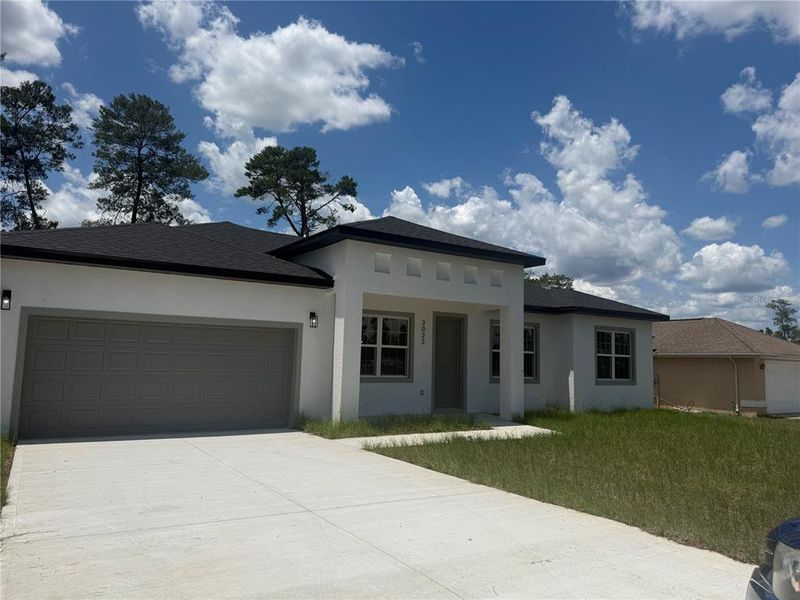 Front exterior of a new home in , Ocala, FL, highlighting curb appeal (Image 1).