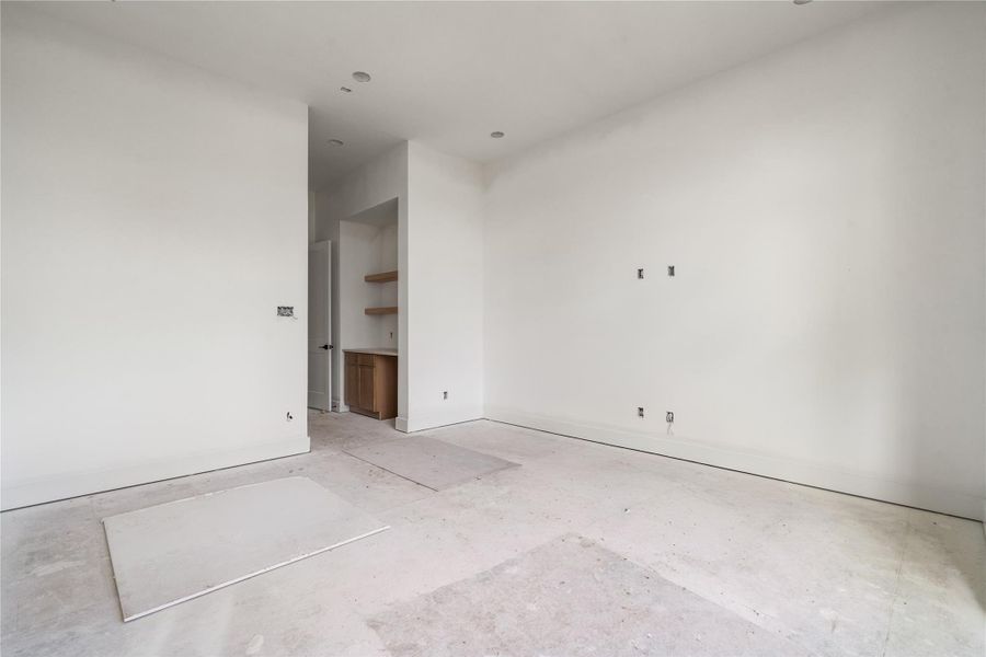 Primary bedroom with large windows.