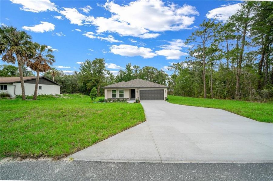 Front exterior of a new home in , Weeki Wachee, FL, highlighting curb appeal (Image 23). Front exterior of a new home in , Weeki Wachee, FL, highlighting curb appeal (Image 23).