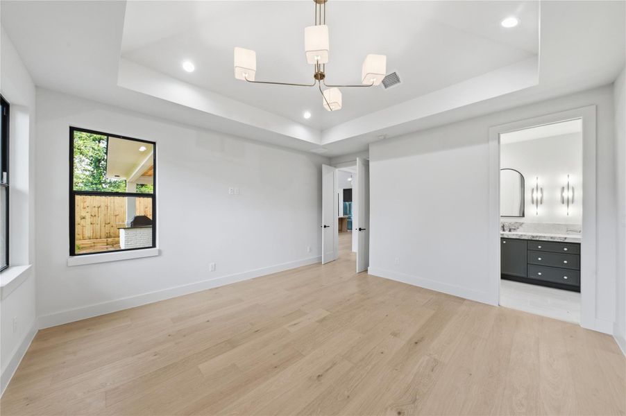 This elegant primary bedroom offers the perfect blend of comfort and sophistication, creating a true private retreat.