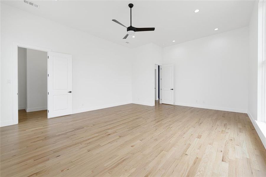 Empty room with a ceiling fan, light wood finished floors, recessed lighting, and baseboards Empty room with a ceiling fan, light wood finished floors, recessed lighting, and baseboards