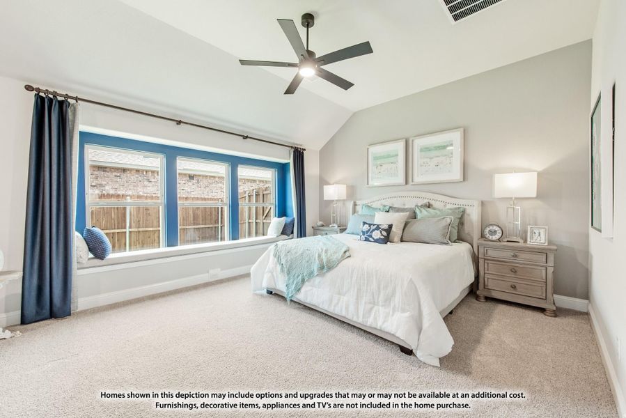 Bedroom with vaulted ceiling, ceiling fan, window seat, and large bay window with blue curtains