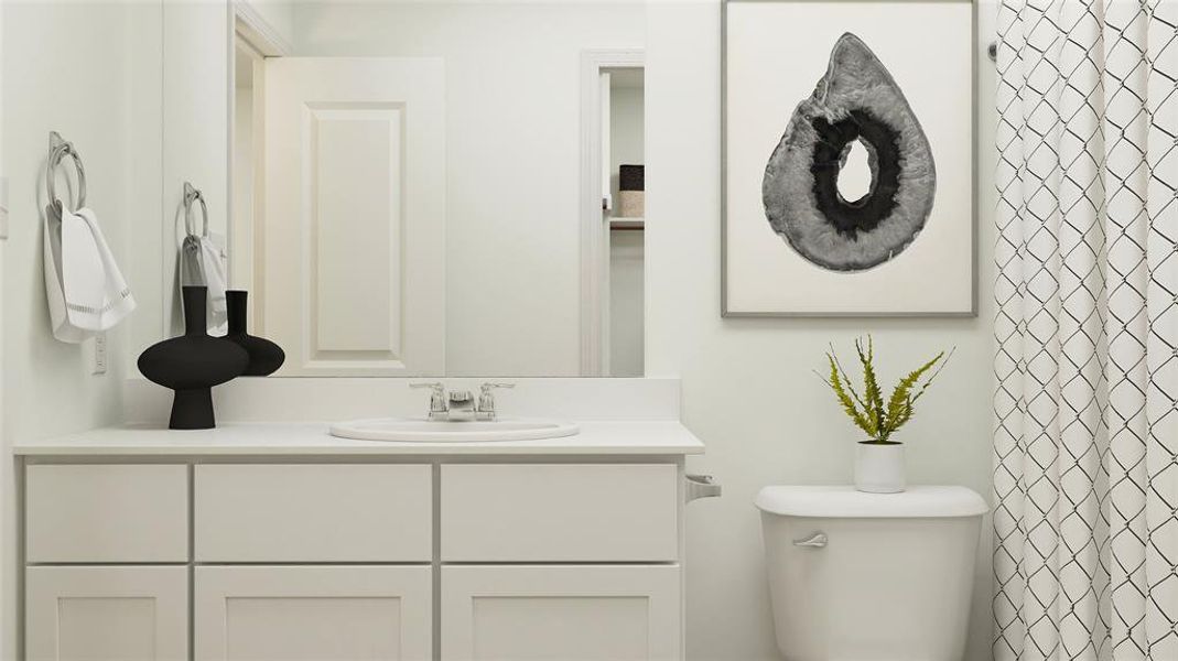 Bathroom featuring vanity and toilet