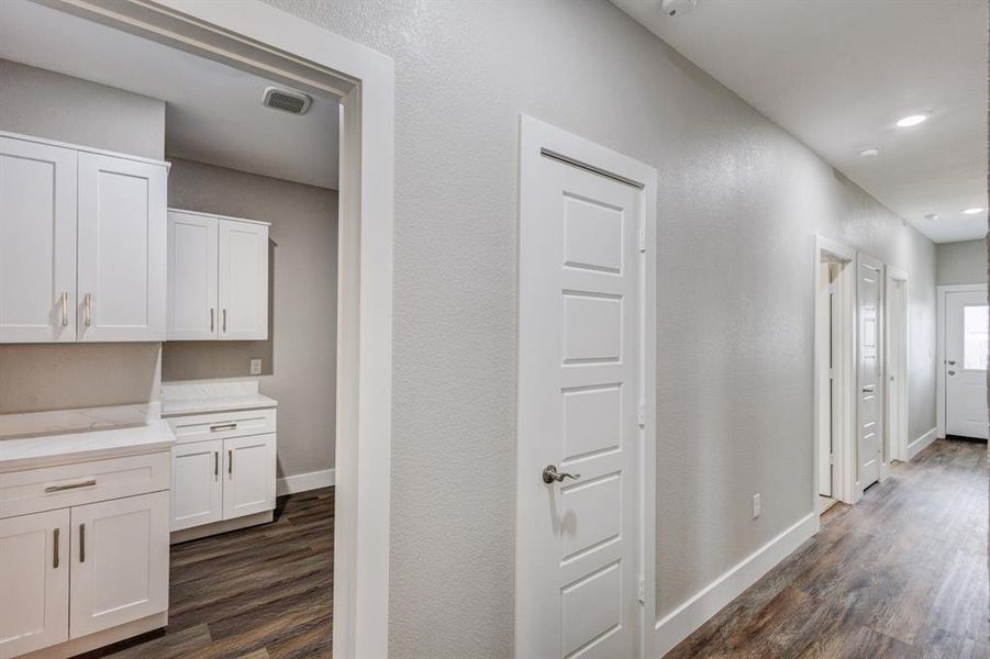 Corridor featuring dark hardwood / wood-style flooring