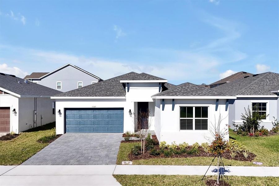 Front exterior of a new home in Prairie Oaks, St. Cloud, FL, highlighting curb appeal (Image 25).