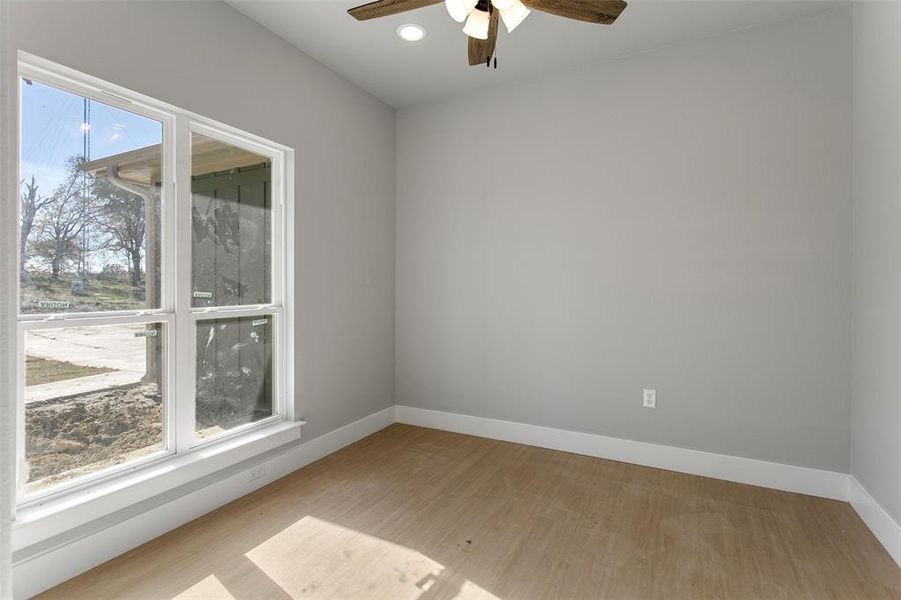 Spare room with ceiling fan and light hardwood / wood-style flooring