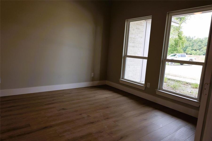 Unfurnished room featuring dark wood-type flooring