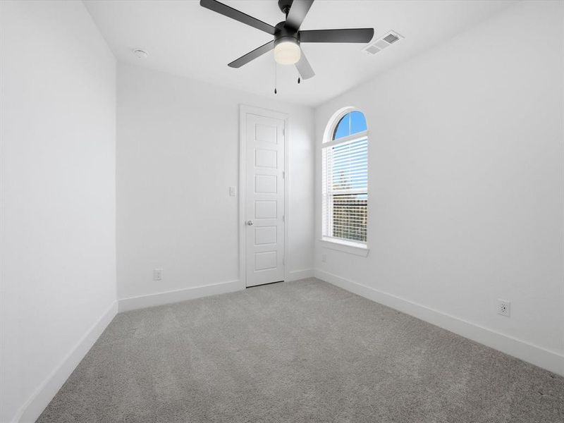 Unfurnished bedroom with carpet floors and a ceiling fan