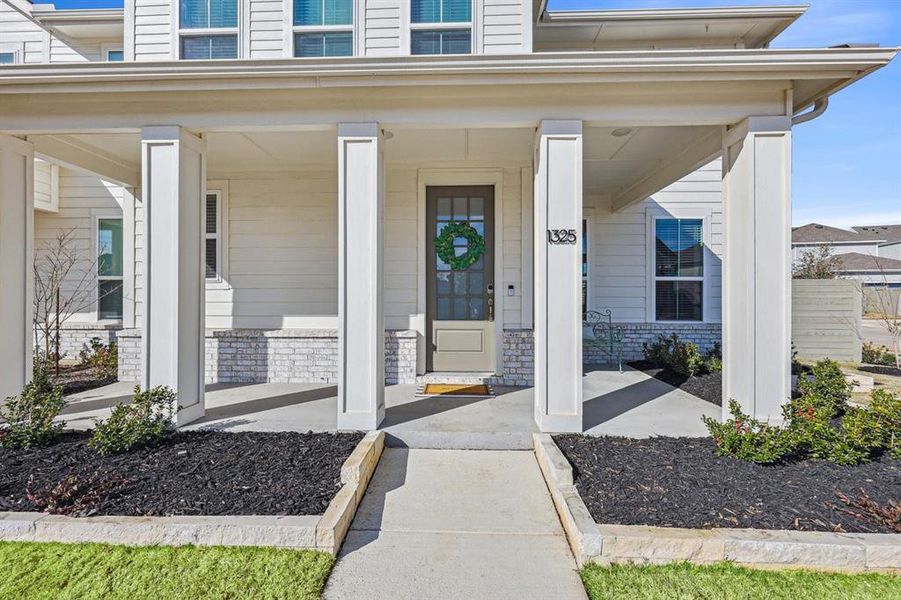 Doorway to property featuring front porch