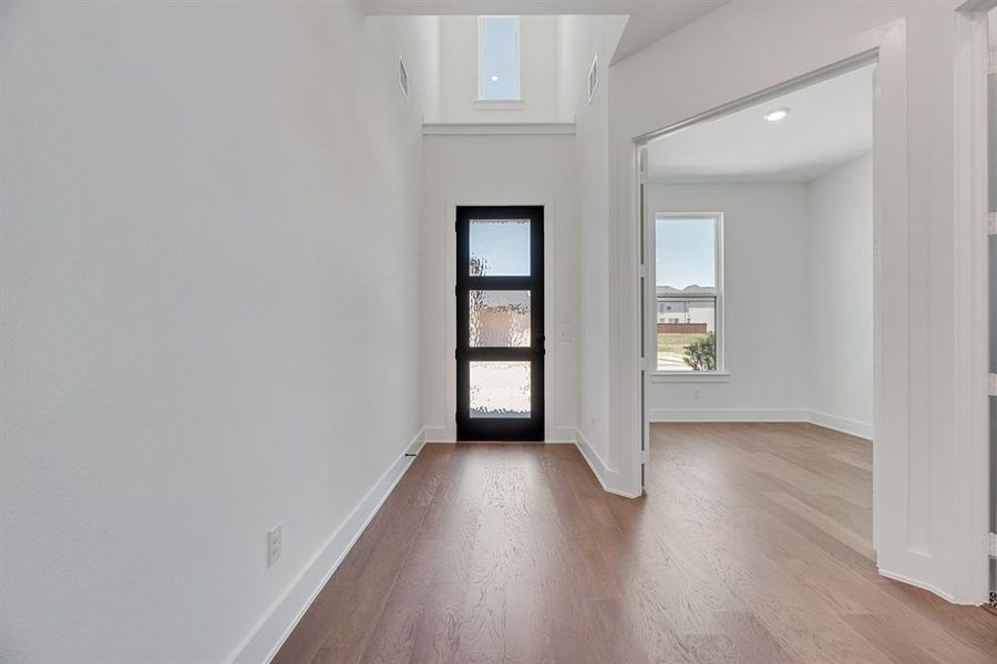 Foyer with light wood-style flooring and recessed lighting Foyer with light wood-style flooring and recessed lighting
