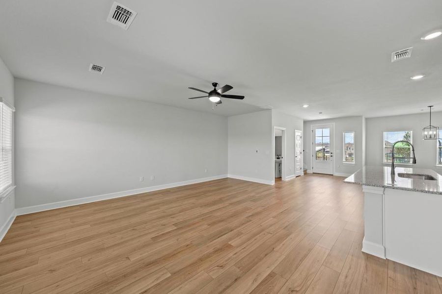 Off the kitchen is the spacious family room, a cozy haven for movie nights and gatherings with friends.