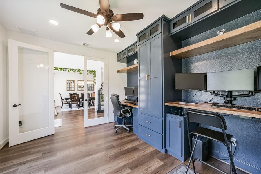 The home office, located off the foyer, features elegant French doors with glass panels and a ceiling fan complete with a light fixture. The home office, located off the foyer, features elegant French doors with glass panels and a ceiling fan complete with a light fixture.