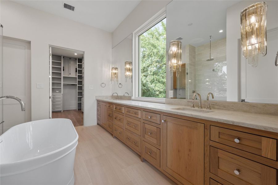 Another view of the primary bath showing a view into the primary closet