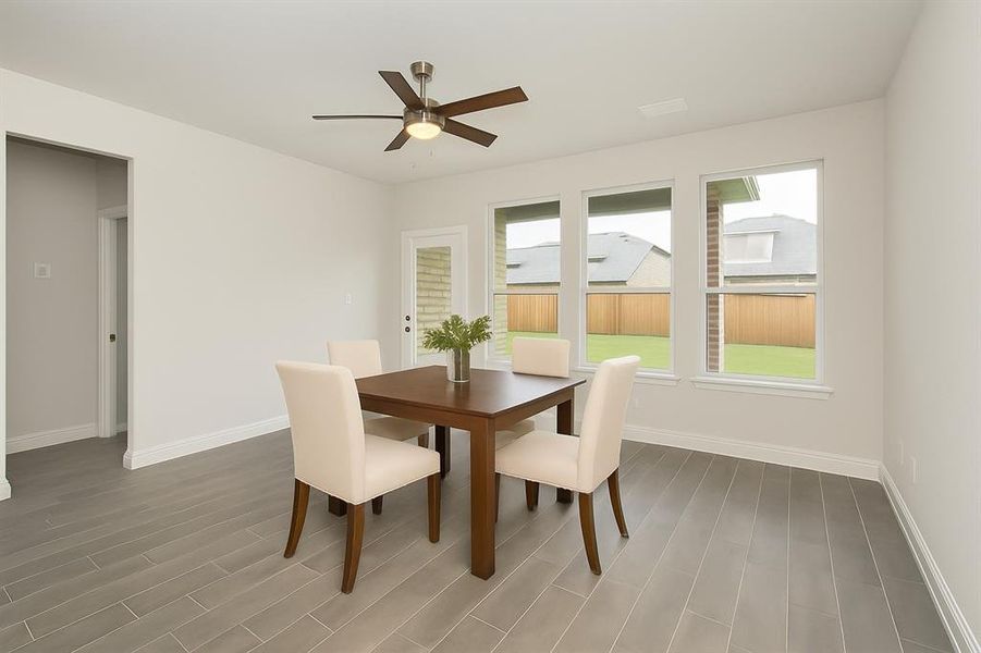 Dining area featuring wood finished floors and ceiling fan Dining area featuring wood finished floors and ceiling fan