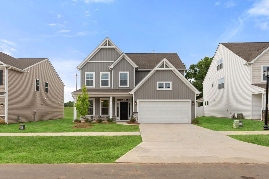 Front exterior of a new home in Monterra, Kernersville, NC, highlighting curb appeal (Image 1). Front exterior of a new home in Monterra, Kernersville, NC, highlighting curb appeal (Image 1).